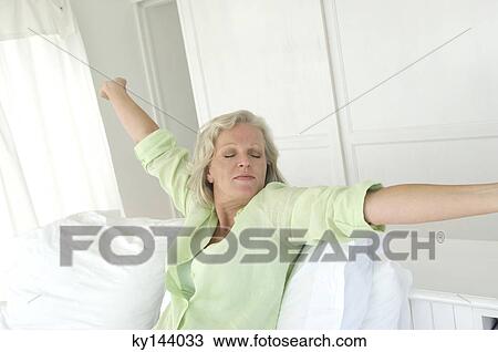 Woman stretching in bed View Large Photo Image Stock Image - Woman stretching in bed. Fotosearch