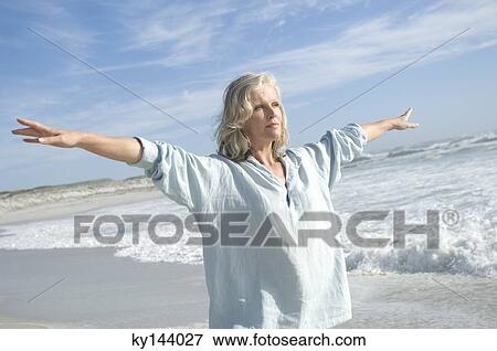 Woman stretching on the beach View Large Photo Image Stock Photo - Woman stretching on the beach. Fotosearch