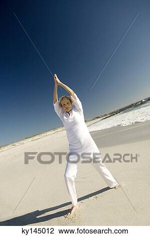 Senior woman doing yoga on the beach View Large Photo Image Stock Image - Senior woman doing yoga on the beach. Fotosearch