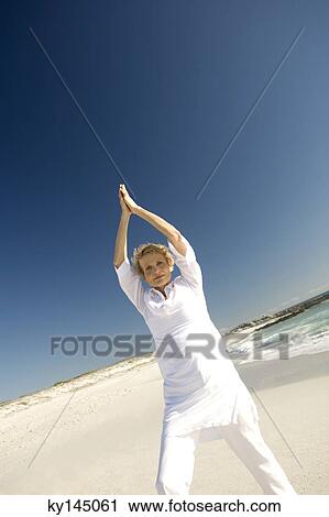 Senior woman doing yoga on the beach View Large Photo Image Stock Image - Senior woman doing yoga on the beach. Fotosearch