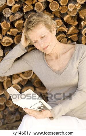 Senior woman reading a book View Large Photo Image Stock Photo - Senior woman reading a book. Fotosearch