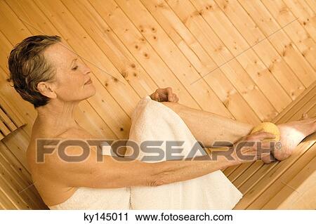 Senior woman sitting in sauna View Large Photo Image Stock Image - Senior woman sitting in sauna. Fotosearch