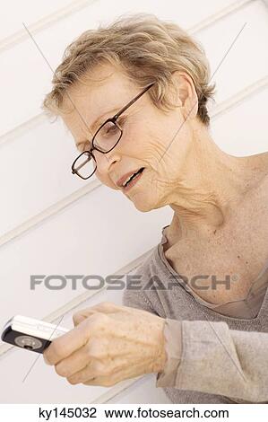 Senior woman using mobile phone View Large Photo Image Stock Image - Senior woman using mobile phone. Fotosearch