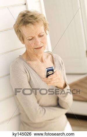Stock Photograph - Senior woman using mobile phone. Fotosearch