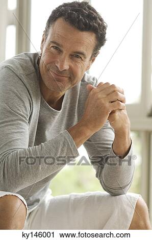 Man looking at the camera, indoors View Large Photo Image Stock Image - Man looking at the camera, indoors. Fotosearch