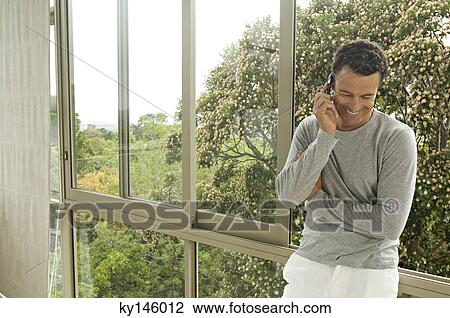 Man phoning, indoors View Large Photo Image Stock Image - Man phoning, indoors. Fotosearch