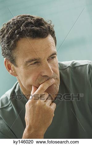 Stock Image - Thoughtfull man's portrait, indoors. Fotosearch
