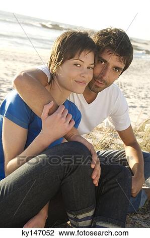Couple embracing on the beach View Large Photo Image Stock Image - Couple embracing on the beach. Fotosearch