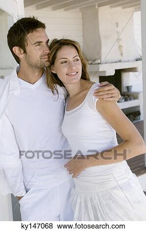 Couple embracing on wooden terrace View Large Photo Image Stock Photo - Couple embracing on wooden terrace. Fotosearch