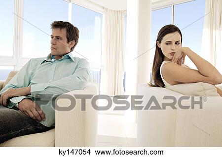 Couple sulking in living-room View Large Photo Image Picture - Couple sulking in living-room. Fotosearch