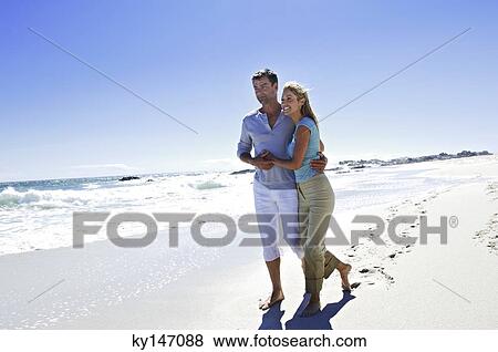 Couple walking on the beach View Large Photo Image Stock Photo - Couple walking on the beach. Fotosearch