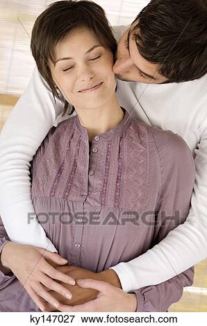 Man kissing young woman with eyes closed View Large Photo Image Stock Photo - Man kissing young woman with eyes closed. Fotosearch