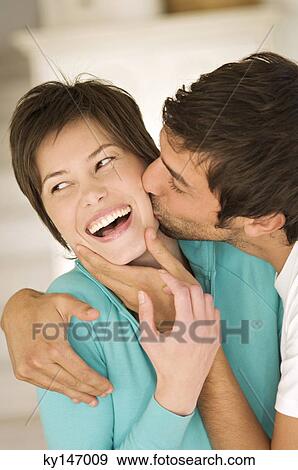 Portrait of man kissing smiling woman View Large Photo Image Stock Photo - Portrait of man kissing smiling woman. Fotosearch