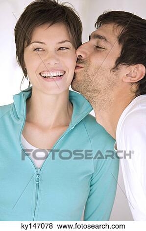 Portrait of man kissing smiling woman View Large Photo Image Stock Photo - Portrait of man kissing smiling woman. Fotosearch