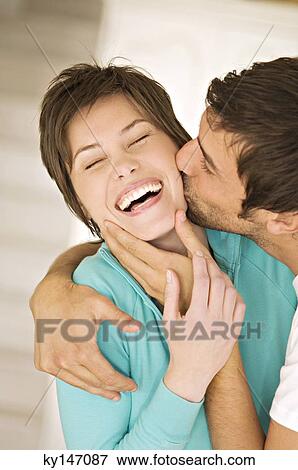 Portrait of man kissing smiling woman View Large Photo Image Stock Photo - Portrait of man kissing smiling woman. Fotosearch
