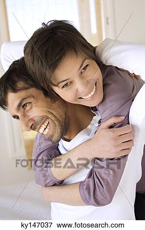 Stock Photo - Smiling couple embracing. Fotosearch