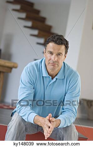 Man sitting, joining hands View Large Photo Image Stock Photo - Man sitting, joining hands. Fotosearch