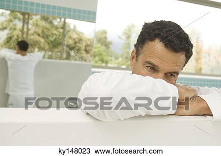 Portrait of thinking man leaning against wall View Large Photo Image Stock Image - Portrait of thinking man leaning against wall. Fotosearch