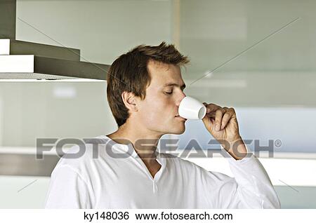 Portrait of young man drinking coffee View Large Photo Image Stock Photograph - Portrait of young man drinking coffee. Fotosearch
