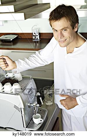 Young smiling man in front of espresso maker View Large Photo Image Stock Photo - Young smiling man in front of espresso maker. Fotosearch