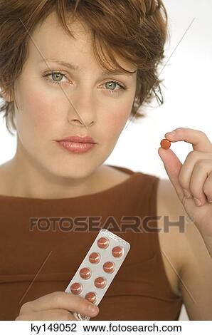 Portrait of a young woman holding pills View Large Photo Image Stock Image - Portrait of a young woman holding pills. Fotosearch