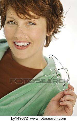 Stock Image - Portrait of young smiling woman with eye glasses. Fotosearch
