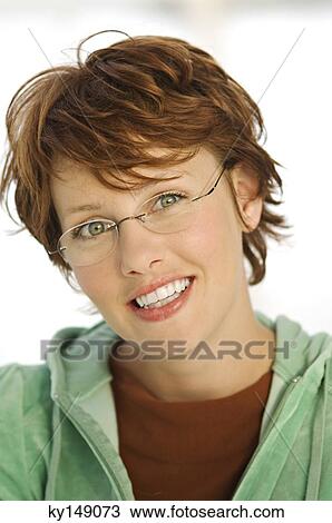 Portrait of young smiling woman with eye glasses View Large Photo Image Stock Image - Portrait of young smiling woman with eye glasses. Fotosearch