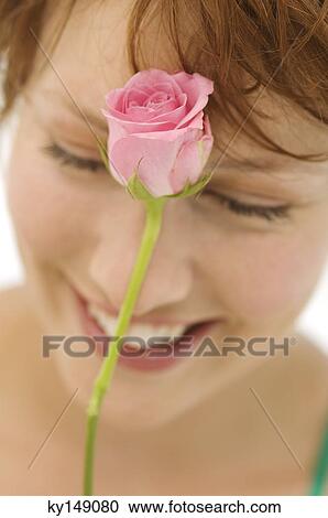Portrait of young smiling woman with rose in front of face View Large Photo Image Stock Image - Portrait of young smiling woman with rose in front of face. Fotosearch