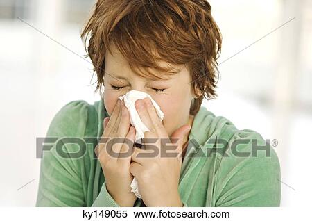 Portrait of young woman blowing her nose View Large Photo Image Stock Photography - Portrait of young woman blowing her nose. Fotosearch