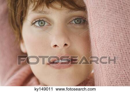 Portrait of young woman looking at camera View Large Photo Image Stock Image - Portrait of young woman looking at camera. Fotosearch