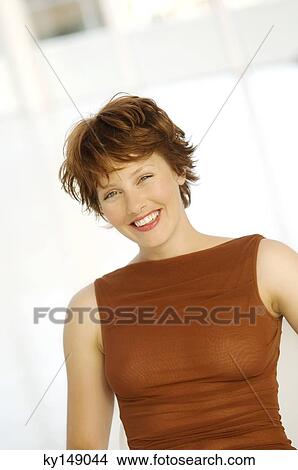 Portrait of young woman smiling for the camera View Large Photo Image Picture - Portrait of young woman smiling for the camera. Fotosearch