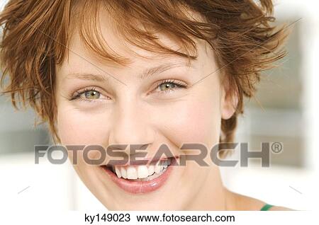 Portrait of young woman smiling for the camera View Large Photo Image Stock Image - Portrait of young woman smiling for the camera. Fotosearch