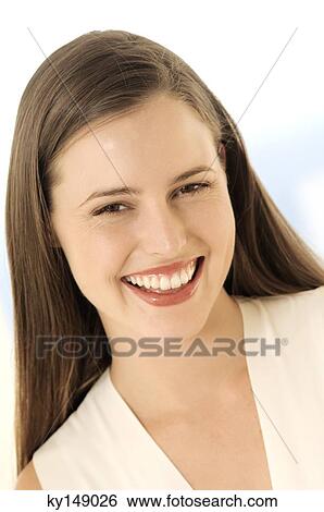 Portrait of young woman smiling for the camera View Large Photo Image Stock Photograph - Portrait of young woman smiling for the camera. Fotosearch