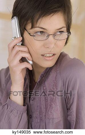 Portrait of young woman using mobile phone View Large Photo Image Stock Photography - Portrait of young woman using mobile phone. Fotosearch
