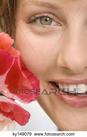 Smiling woman with flower View Large Photo Image Stock Photo - Smiling woman with flower. Fotosearch