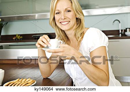 Young smiling woman holding coffee cup View Large Photo Image Picture - Young smiling woman holding coffee cup. Fotosearch