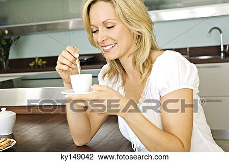 Young smiling woman holding coffee cup View Large Photo Image Stock Image - Young smiling woman holding coffee cup. Fotosearch