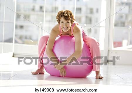 Young smiling woman resting on big pink ballon View Large Photo Image Stock Photo - Young smiling woman resting on big pink ballon. Fotosearch