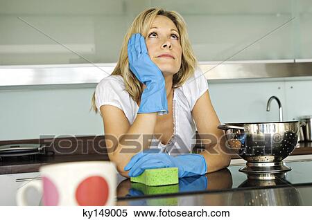 Young woman daydreaming in kitchen View Large Photo Image Stock Photography - Young woman daydreaming in kitchen. Fotosearch
