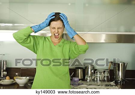 Young woman screaming in kitchen, hands on head View Large Photo Image Stock Image - Young woman screaming in kitchen, hands on head. Fotosearch