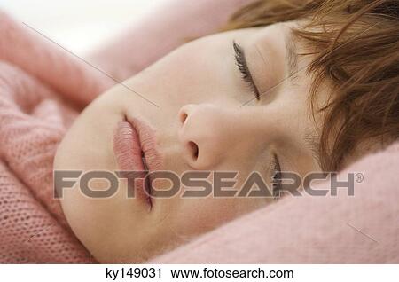 Young woman sleeping, close-up of face View Large Photo Image Stock Image - Young woman sleeping, close-up of face. Fotosearch
