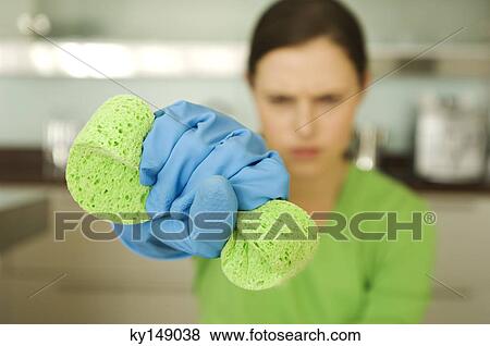 Young woman wringing sponge View Large Photo Image Stock Photo - Young woman wringing sponge. Fotosearch