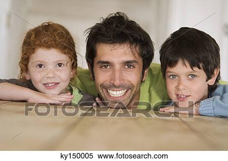 Father and 2 children smiling for the camera View Large Photo Image Stock Photography - Father and 2 children smiling for the camera. Fotosearch