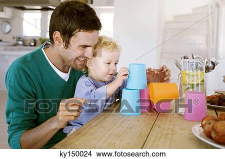 Father and son playing in kitchen View Large Photo Image Picture - Father and son playing in kitchen. Fotosearch