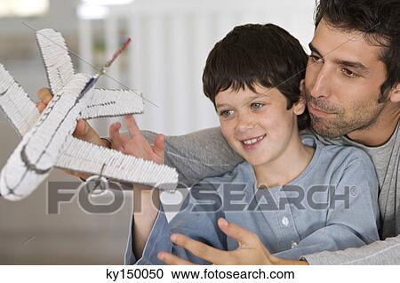 Father and son playing with model aeroplane View Large Photo Image Stock Image - Father and son playing with model aeroplane. Fotosearch