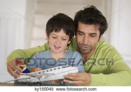 Father and son playing with model aeroplane View Large Photo Image Stock Photography - Father and son playing with model aeroplane. Fotosearch