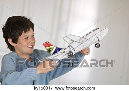 Little boy playing with model aeroplane View Large Photo Image Stock Photo - Little boy playing with model aeroplane. Fotosearch