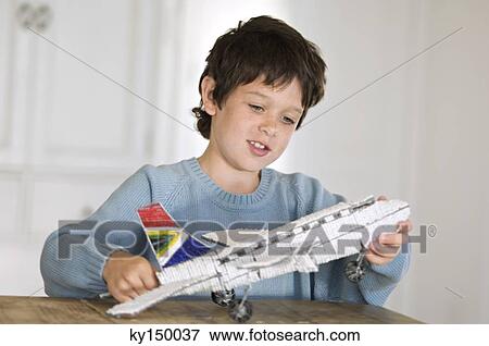 Little boy playing with model aeroplane View Large Photo Image Stock Photo - Little boy playing with model aeroplane. Fotosearch