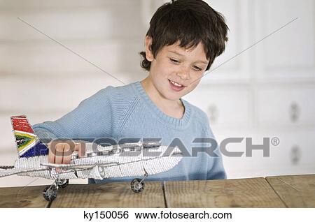 Little boy playing with model aeroplane View Large Photo Image Stock Photograph - Little boy playing with model aeroplane. Fotosearch