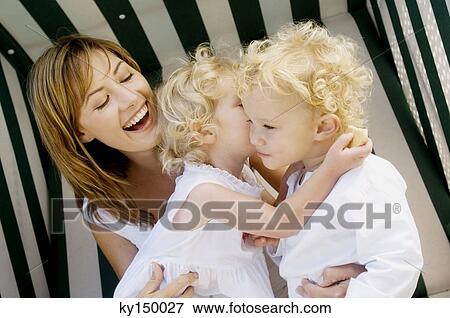 Mother and 2 children on a swing chair View Large Photo Image Stock Photo - Mother and 2 children on a swing chair. Fotosearch
